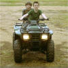 ATV fun. Jonathon Gassaway on atv with a friend.The term "All-Terrain Vehicle" or ATV is used in a general sense to describe any of a number of small open motorized buggies and tricycles designed for off-road use.ATVs were made in the United States a decade before 3- and 4-wheeled vehicles were introduced by Honda and other Japanese companies. During the 1960s numerous manufacturers offered similar small off-road vehicles, that were designed to float and were capable of traversing swamps, ponds and streams as well as dry land. Typically constructed from a hard plastic or fiberglass "tub", they usually had six wheels - all driven - with low pressure (around 3 PSI) balloon tires, no suspension (other than what the tires offered) and used a skid-steer steering setup. These early amphibious models were the original all-terrain vehicles - or ATVs. Contrary to todays ANSI definition of an ATV, they were intended for multiple riders, sitting inside, and would usually have steering wheels or control sticks rather than motorcycle-type handle bars as stipulated in the current definition.
